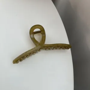 Minimalist olive green acrylic hair claw clip, chic cross design for daily elegant styling.