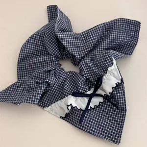 Navy blue plaid hair scrunchie with white lace trim and cute bowknot ponytail holder accessory.