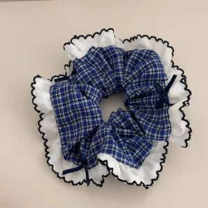Blue plaid scrunchie detail, white lace ruffle trim, elegant bow hair accessory.