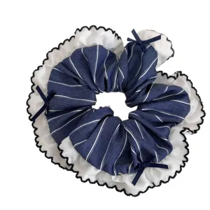 Navy blue striped hair scrunchie with white lace ruffle and cute bowknot main view.