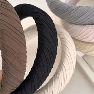 Pleated fabric headband detail showing soft crinkled texture and multi-color layered design.