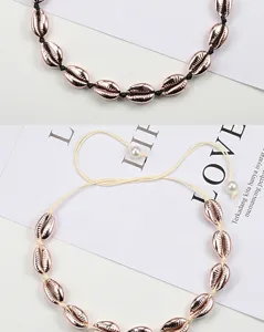 Close-up detail of bohemian rose gold electroplated seashell choker necklace with adjustable cord.