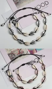 Vista dettagliata di bracciali con conchiglie intrecciate fatti a mano in argento e oro.