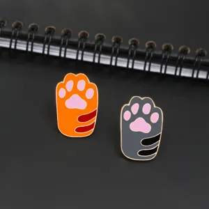 Cute cat paw enamel pin set featuring orange and grey tabby designs for sweet outfits and bags.