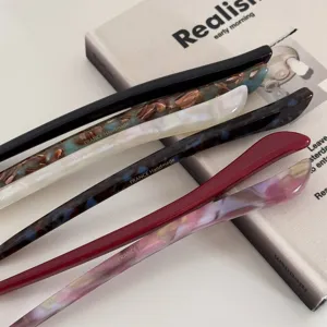 Detailed view of minimalist acetate hair sticks in various colors, sleek handmade hair pin.