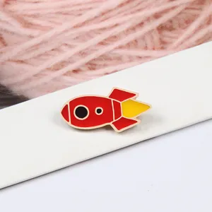 Cute cartoon rocket enamel pin for kids and fashion apparel, alloy brooch badge accessory.