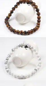 Detailed view of natural stone beaded bracelets, smooth round beads, elegant jewelry design.