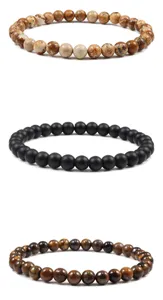 Close view of three natural stone beaded bracelets showing jasper, matte black, and tiger's eye styles.
