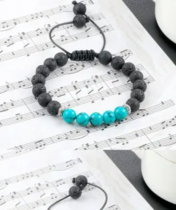 Detail van de lavasteen en turkoois kralen armband, verstelbare gevlochten yoga armband.