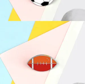 Rugby football enamel pin detail shot showing alloy metal texture and vibrant color enamel finish.