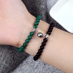 Magnetic couple bracelet with 6mm green and black beads, stylish design for men and women.