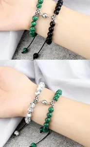Detail shot of magnetic couple beaded bracelets, featuring malachite and stone design on wrist.
