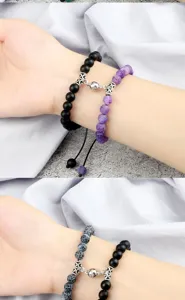 Detailed view of the magnetic attraction couple beaded bracelets showing fine metal clasps.