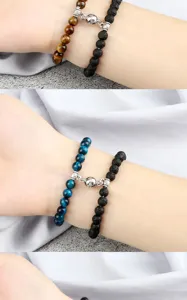 Close-up detail of magnetic couple beaded bracelets with 6mm tiger eye and lava stones.