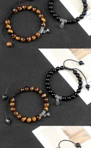 Handmade beaded magnetic couple bracelets set with tiger eye and black stone charms for lovers.