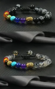 Close-up detail of the chakra beaded bracelet featuring a gold Buddha head and natural stone beads.