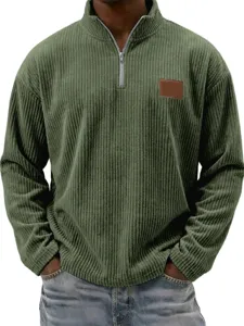Detailed view of olive green corduroy quarter zip pullover shirt close up texture.