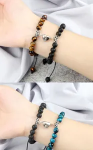 Detail shot of matching magnetic heart braided bracelets with natural stone beads for couples.