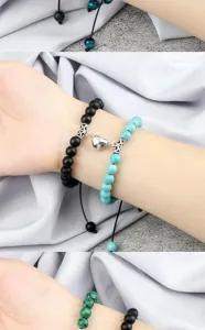 Handmade braided couple bracelet detail shot featuring magnetic heart charm and natural stone beads.