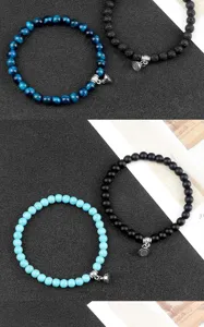 Detailed view of magnetic couple beaded bracelets featuring natural stone beads and charms.