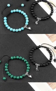 Detail view of matching distance couple bracelets with magnetic heart pendants and natural stones.