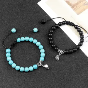 Couple distance magnetic bracelets with heart charm and adjustable braided rope for lovers.