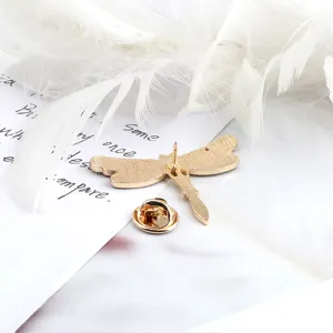 Gold tone dragonfly brooch pin back display, elegant accessories for jacket collar and bags.