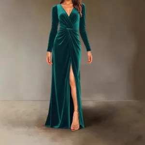 Detail shot of dark green velvet long sleeve evening dress featuring front ruched design and slit.