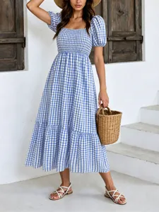 Robe mi-longue rétro à carreaux vichy bleus, manches bouffantes, col carré et volants.