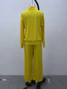 Yellow athletic tracksuit back detail featuring mock neck top and wide leg pants set.