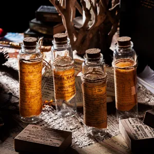 Vintage glass bottles set with cork stoppers and rustic twine wrapped antique labels for decor.