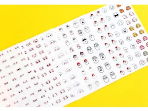 Detailed close-up view of cute cartoon expression sticker sheets featuring various funny designs.