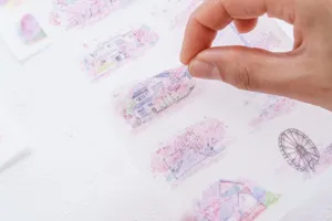 Close-up detail of watercolor cherry blossom sticker sheet, perfect for journal decoration.
