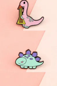 Close-up detail of cute cartoon dinosaur metal enamel brooches, trendy bag lapel pins decorations.