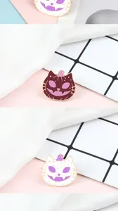 Close-up detail shot of cute Halloween pumpkin cat enamel pin, metal brooch accessory.