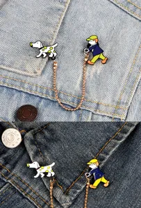 Cute cartoon person walking dog brooch pin with chain, creative metal badge for denim jacket.