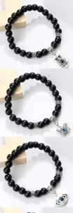 Bracelet en perles noires mates avec pendentif oeil malefique hibou papillon yoga chic.