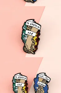 Creative cartoon alloy enamel brooch featuring flame hand and letter ribbon design for chic decor.