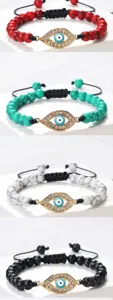 Bracelet de perles mauvais œil avec pendentif œil doré en strass et cordon tressé réglable.