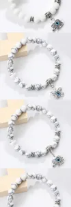 Details bracelet de perles howlite blanche, charms mauvais oeil elephant papillon.