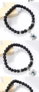 Bracelet de perles en pierre de lave noire avec pendentifs tortue et papillon œil maléfique.