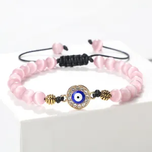 Charmant bracelet de perles roses avec pendentif œil bleu strass et cordon réglable élégant.