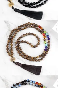 Multi-layer beaded necklace detail with obsidian wood beads tree of life tassel pendant.