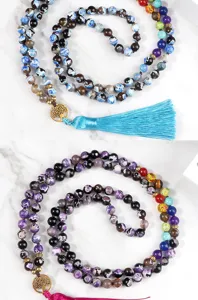 Detailed view of multi-layer beaded tassel necklace with chakra stones and tree of life charm.