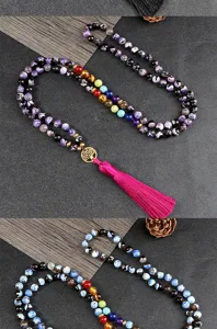 Detailed view of multi-layer beaded chakra tassel bracelet with tree of life pendant.