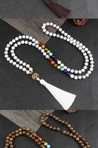 Details of multi-layer beaded necklace featuring tree of life pendant and colorful chakra stones.