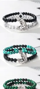Close-up detail of layered magnetic couple bracelets with stone beads and heart charms.