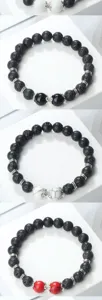 Bracelet en perles de pierre de lave avec entretoises en métal et perles centrales.