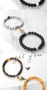 Detail view of magnetic couple bracelets featuring natural stone beads and gold silver hands clasp.