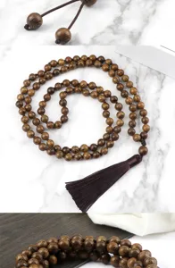 Wood beaded necklace and sweater chain detailed view featuring classic Chinese style tassel.